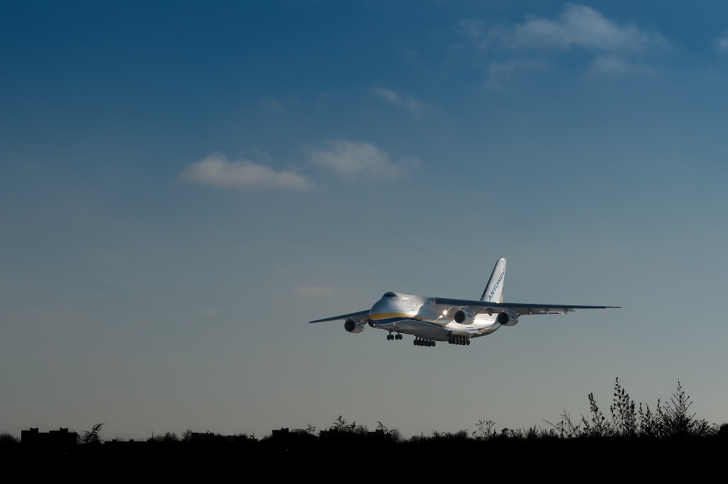 a large jetliner flying through a blue sky